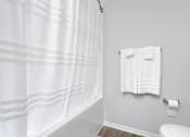 Thumbnail 12 of 35 - A white shower curtain in a bathroom.