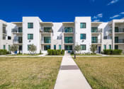 Thumbnail 50 of 78 - modern apartment buildings with grass and a sidewalk at Altis Blue Lake, Florida, 33467