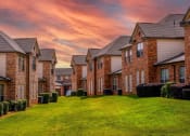 Thumbnail 3 of 69 - a row of brick houses on a green lawn