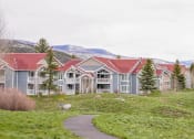 Thumbnail 15 of 20 - a group of houses with mountains in the background