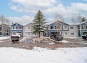 Thumbnail 42 of 43 - a row of houses with trucks parked in the snow