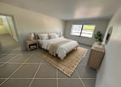 Thumbnail 5 of 15 - A bedroom with a large bed and a mirror on the side.
