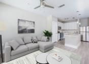 Thumbnail 2 of 36 - a living room with a couch and a table