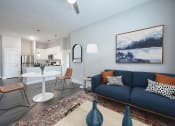Thumbnail 6 of 36 - a living room with a blue couch and a white table and chairs