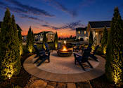 Thumbnail 58 of 65 - A backyard with a fire pit and chairs.
