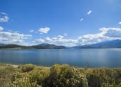 Thumbnail 27 of 43 - a view of a lake with mountains in the background
