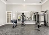 Thumbnail 15 of 18 - A spacious home gym with a variety of exercise equipment.