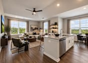 Thumbnail 2 of 25 - A modern kitchen and living room with a ceiling fan and large windows.