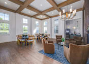Thumbnail 9 of 16 - A large room with wooden floors and furniture.