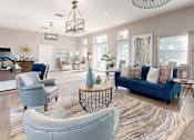 Thumbnail 2 of 26 - A living room with a blue couch and a grey armchairl at Fountains of Largo, Largo, 33774