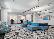 Thumbnail 2 of 34 - A modern living room with a black and white patterned carpet.