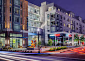Thumbnail 1 of 25 - A Smashburger restaurant is lit up at night.