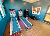Thumbnail 7 of 23 - A room with a bowling alley setup and two bowling pins.