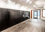 Thumbnail 4 of 7 - a row of black lockers in a white room with a door