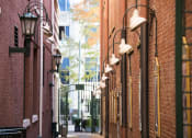 Thumbnail 5 of 7 - a city street with red brick buildings and street lights