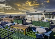 Thumbnail 2 of 7 - a rooftop terrace with tables and chairs and a view of the city