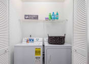 Thumbnail 9 of 23 - A small laundry room with a washer and dryer.