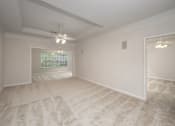 Thumbnail 21 of 43 - A room with a carpeted floor and a ceiling fan.