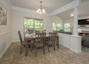 Thumbnail 13 of 43 - A dining room with a table and chairs.