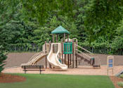 Thumbnail 36 of 43 - A playground with a green roofed structure and a slide.