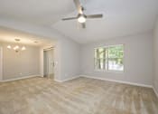 Thumbnail 8 of 23 - A room with a ceiling fan and a window with blinds.