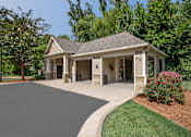 Thumbnail 9 of 50 - A house with a grey roof and a driveway in front.