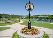 Thumbnail 56 of 58 - a view of a park with a clock in the middle