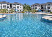 Thumbnail 22 of 58 - a large swimming pool with apartments in the background