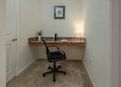 Thumbnail 20 of 36 - A small room with a desk and a chair.