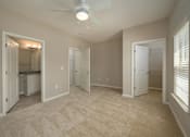 Thumbnail 15 of 48 - A room with a ceiling fan and a carpeted floor.