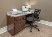 Thumbnail 14 of 37 - A brown desk with a printer and a sign that says "Greystone Homes".