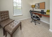 Thumbnail 24 of 37 - A brown leather chair and ottoman are in a room with a desk and a window.