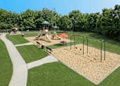 Thumbnail 17 of 37 - A playground with a slide, swings, and a sandbox.