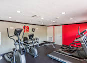 Thumbnail 9 of 15 - A gym with treadmills, elliptical machines, and other exercise equipment.