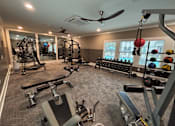 Thumbnail 25 of 26 - A spacious home gym with a variety of equipment.