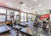 Thumbnail 10 of 15 - 3-Bedroom Luxury Apartments In Hollywood, FL - Park Hill Hollywood - A Professional Indoor Gym With Vision Fitness Treadmills, Ellipticals, And A Large Wall Mirror.