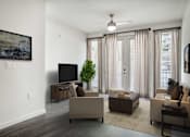 Thumbnail 15 of 40 - A living room with a television, two couches, and a plant.