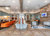 Thumbnail 2 of 40 - A modern living room with a stone wall and a TV.