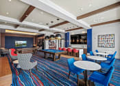 Thumbnail 27 of 78 - a lounge area with a pool table and tables and chairs at Altis Blue Lake, Lake Worth, Florida