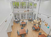 Thumbnail 5 of 30 - a large room with tables and chairs and a ceiling fan