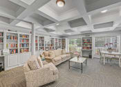Thumbnail 7 of 30 - a living room with couches and bookshelves