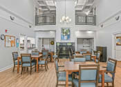 Thumbnail 4 of 30 - a large dining room with tables and chairs and a fireplace