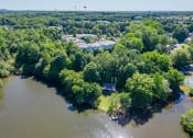 Thumbnail 30 of 30 - an aerial view of a body of water surrounded by trees