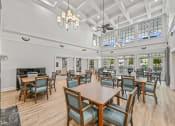Thumbnail 6 of 30 - a large dining room with tables and chairs and a fireplace
