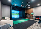 Thumbnail 32 of 45 - A room with a large screen and a green mat in front of it.