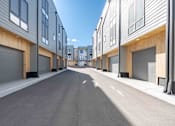 Thumbnail 40 of 45 - A long street with apartment buildings on both sides.