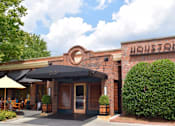Thumbnail 36 of 39 - A restaurant named Houston's has a black awning and a brick exterior.