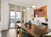 Thumbnail 67 of 72 - A modern dining room with a wooden table and chairs.