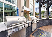 Thumbnail 53 of 72 - A stainless steel outdoor grill is on a wooden deck.