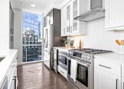 Thumbnail 20 of 80 - A modern kitchen with stainless steel appliances and white cabinets.